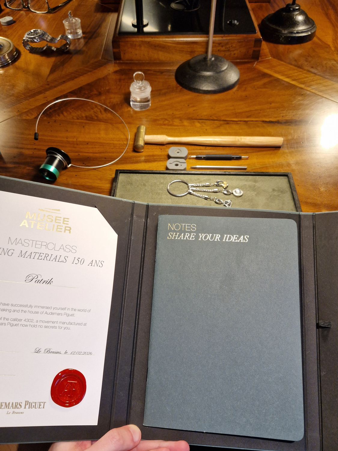 AP Master Watchmaker workshop certificate and watchmaker's bench