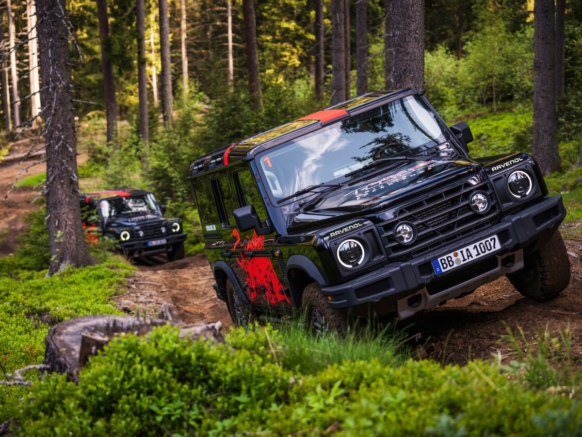 Ineos Grenadier vehicles on a forest off-road trail